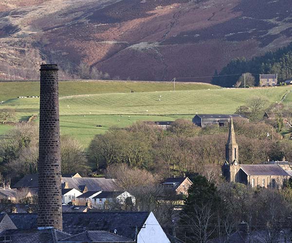 a view over sabden parish with st nicholas church in the background